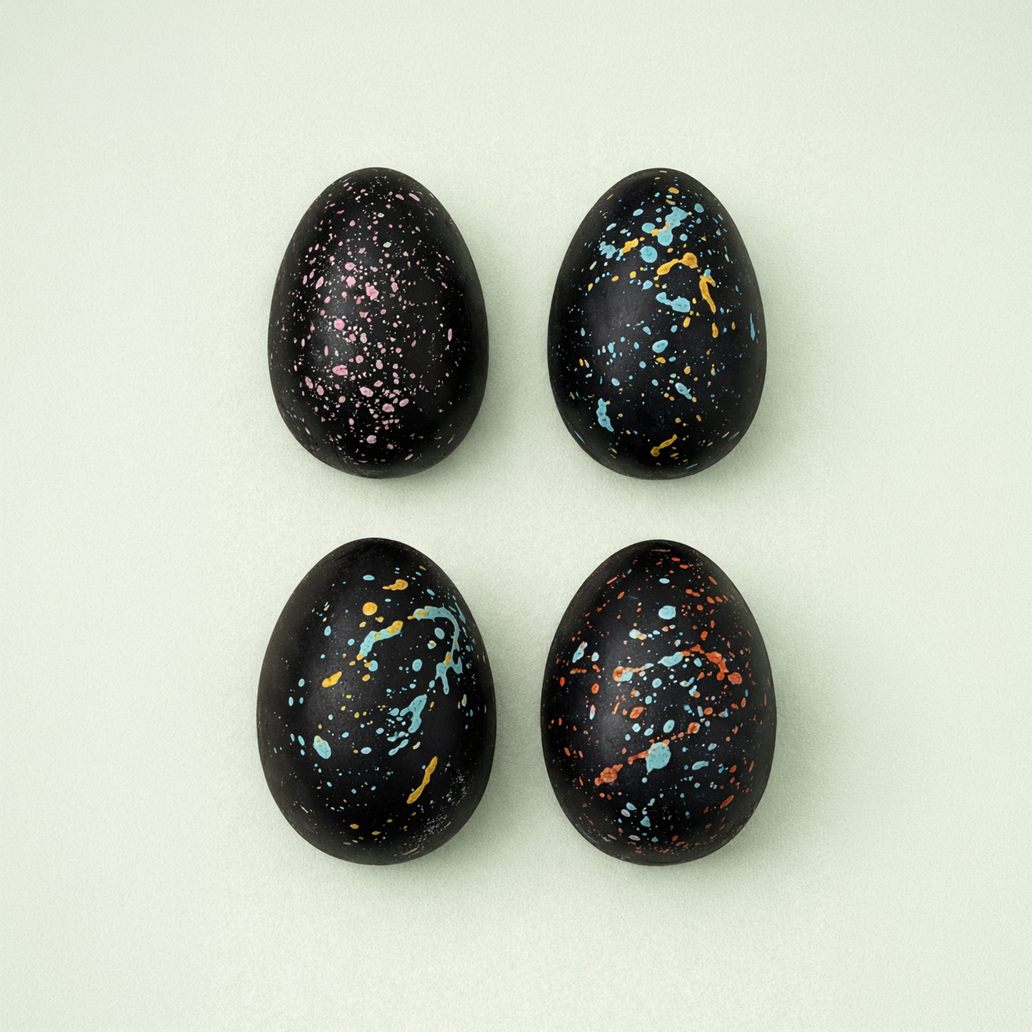 Hand painted dark chocolate Easter eggs with colorful splashes