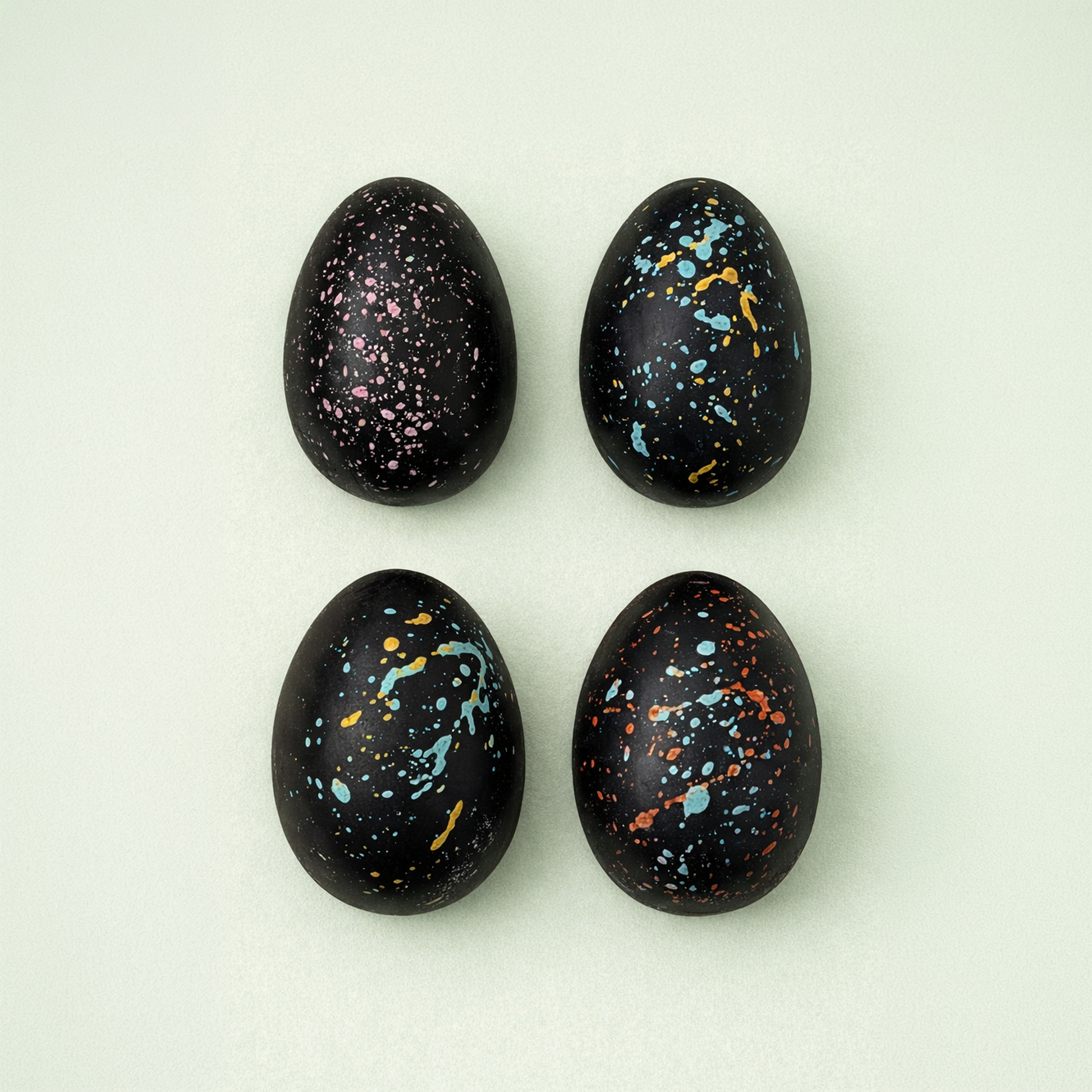 Hand painted dark chocolate Easter eggs with colorful splashes